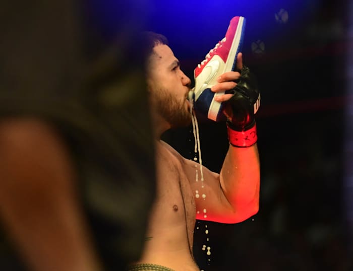 Tai Tuivasa performs his signature shoey and celebrates after knocking out Greg Hardy at UFC 264. 